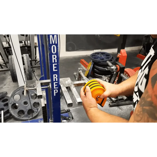 Orange and yellow knee wraps  been wrapped with Kiwi-Strength Heavy-Duty Wrap Roller